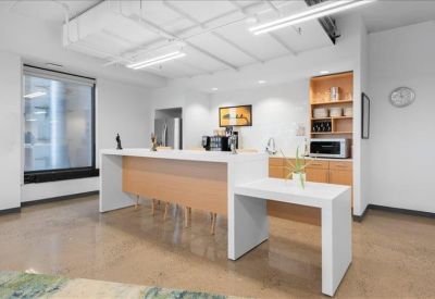 Bright communal kitchen and breakout area with a large island and coffee station.