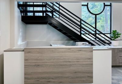 Elegant lobby seating area with gold accents and a large arched window.