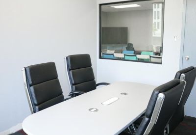 Spacious classroom setup with wooden desks and ergonomic seating, 1903 Central Drive, Bedford, Texas.