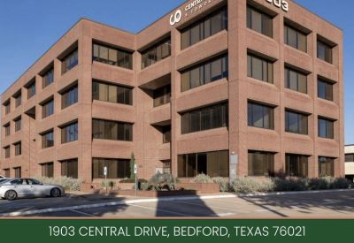 Small meeting room with white table and black leather chairs, 1903 Central Drive, Bedford, Texas.
