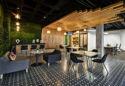 Spacious communal lounge at 2101, Paseo de las Américas, Guadalupe with wooden slats and a green feature wall.