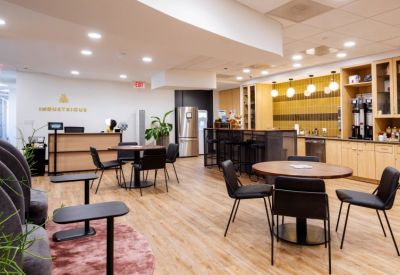 Bright reception area with wood accents and a branded desk.