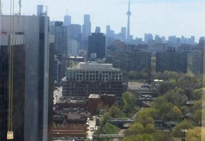 Elevated view of the surrounding city skyline and lush green parkland.