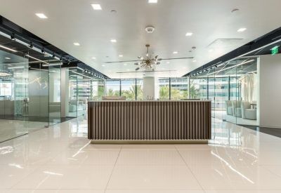 Sleek reception area featuring a wood-slat desk and polished floors.