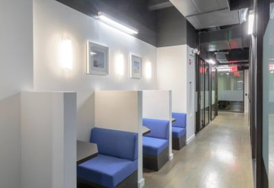 Modern hallway featuring private blue seating booths.