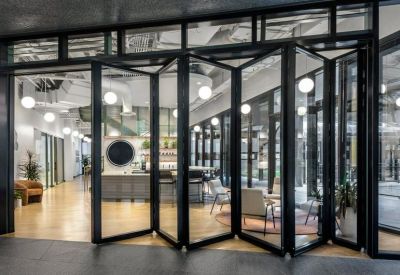 Modern reception area with folding glass doors and contemporary seating.
