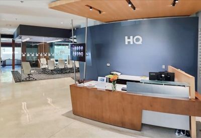 Welcoming reception desk with wood finishes and branded blue backdrop.