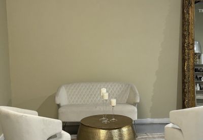 Chic sitting area featuring a velvet loveseat and hammered gold coffee table.
