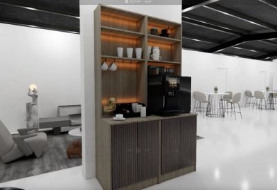 Bright reception lobby with a grey sectional sofa and view of the workspace.
