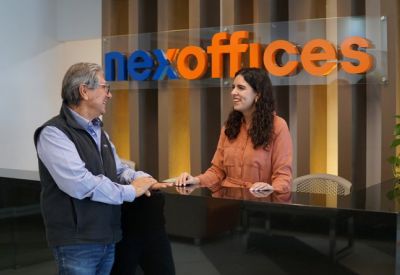 Bright reception desk with wood paneling and orange brand signage.