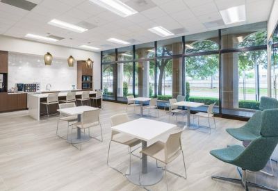 Spacious communal dining area with modern seating and floor-to-ceiling windows.