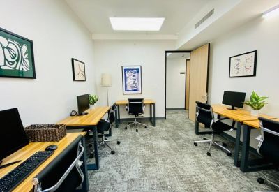 Internal office space featuring several desks, wall art, and a bright skylight.