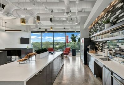 Spacious modern kitchen and breakout area with a large island and window views.