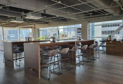 Bar-style seating area with high stools and large windows.