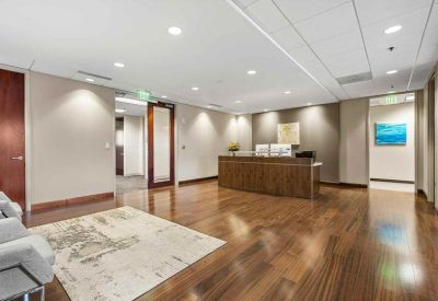 Spacious reception area with polished wood floors and a professional front desk.