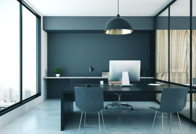 Spacious executive office with a dark feature wall, large desk, and city views through floor-to-ceiling windows.