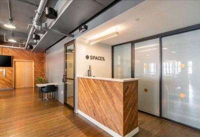 Reception desk with wood paneling and a modern glass entryway.