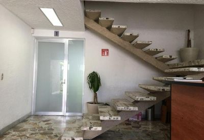 Modern hallway featuring a glass door and an artistic open-tread staircase.