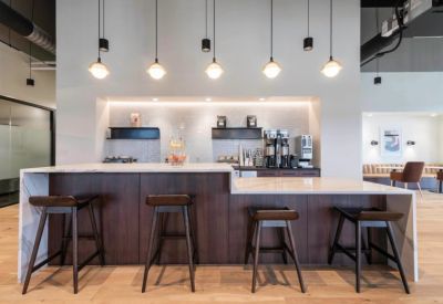 Sleek coffee bar and kitchen area with dark wood cabinetry.