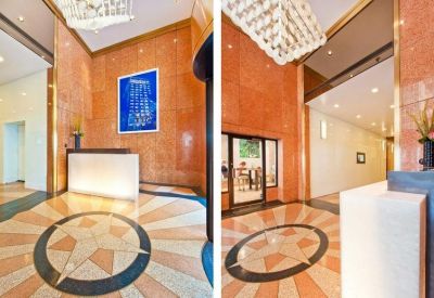 Grand lobby at 469 Fashion Avenue, 12th Floor with marble flooring and geometric star pattern.