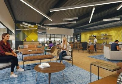 Comfortable breakout lounge with leather benches, blue rugs, and a vibrant yellow accent wall.