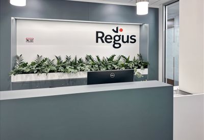 Regus reception area with green plants and desk