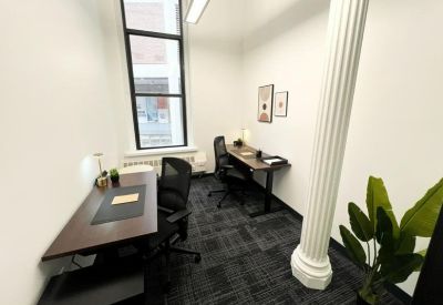 Private two-person office suite with white walls and a large fluted column.