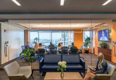 Large glass-walled meeting room with natural light and views of the city.