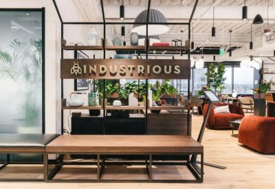 Branded reception area with a wooden bench and built-in shelving displaying plants and decor.