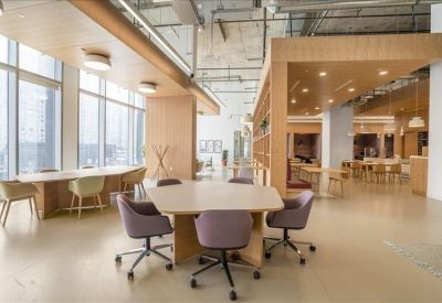 Bright coworking lounge with wooden accents and various seating options.