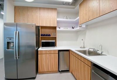 Small corner office area with teal walls and blue seating.