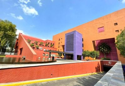 Exterior view of the colorful orange and purple building at 600, Calle Guillermo Haro, Santa Fe, Mexico City.