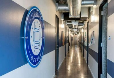 Corridor featuring blue and white wall graphics and a circular company logo.