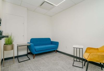 Vibrant communal lounge with a bright blue sofa and yellow armchair.