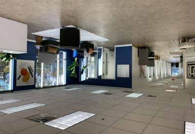 Spacious waiting area with blue feature walls and a large abstract painting.