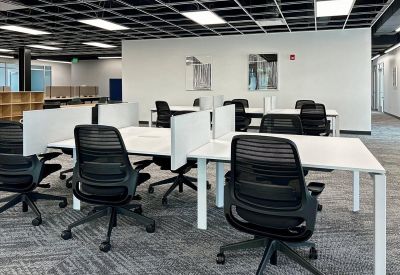 Spacious open-plan workspace at 701 South Main Street, 1st Floor, Logan (UT) with rows of desks and ergonomic chairs.