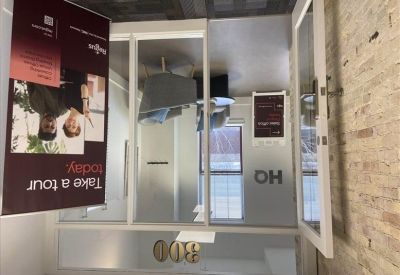 Glass-walled entrance to the office suite featuring a branded welcome sign.