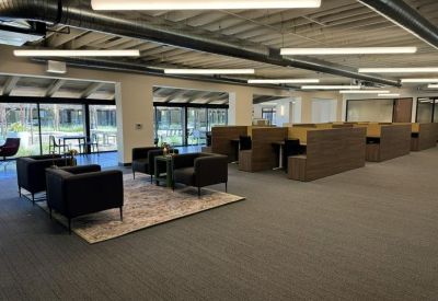 Large open-plan lounge and coworking area with modern partitions and comfortable seating areas.