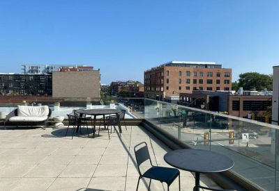 Rooftop terrace with outdoor dining sets and city views.