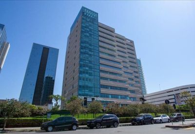 Professional meeting room with a large rectangular table and several grey chairs.
