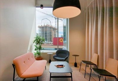 Collaborative workspace with a long wooden table and motivational wall text.