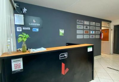 Modern black reception desk with branded logo and grey feature wall.