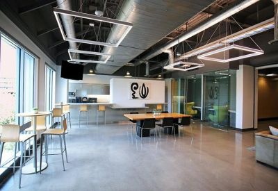 Bright open-plan workspace with high-top seating and floor-to-ceiling windows.