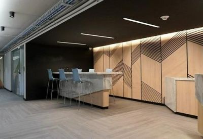 Reception desk with geometric wood-paneled feature wall.
