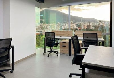 Bright workspace with mountain views and multiple workstations.