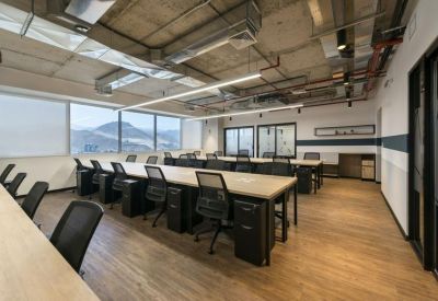 Open plan office with long desks and ergonomic chairs, Avenida Manuel Olguín 327, Lima, Peru.