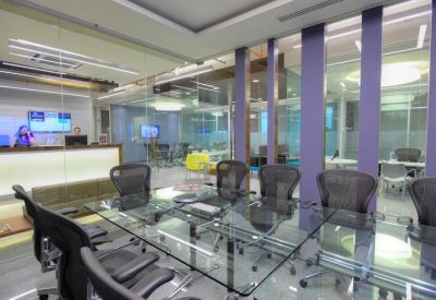 Sleek reception area with glass walls and purple accent pillars.