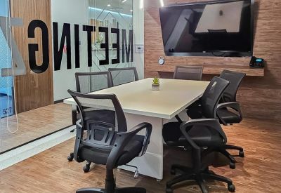 Contemporary meeting room with an rectangular table and wood-paneled walls.