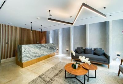 Sleek reception area at Calle 20 No. 438, Colonia México, Merida featuring a marble desk and zig-zag light.