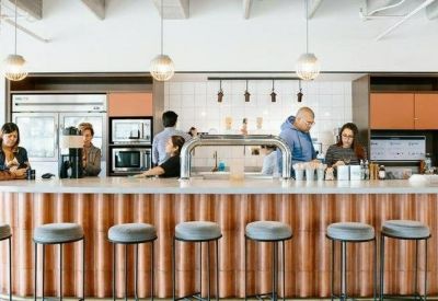 Communal café area with a large central bar and seating.